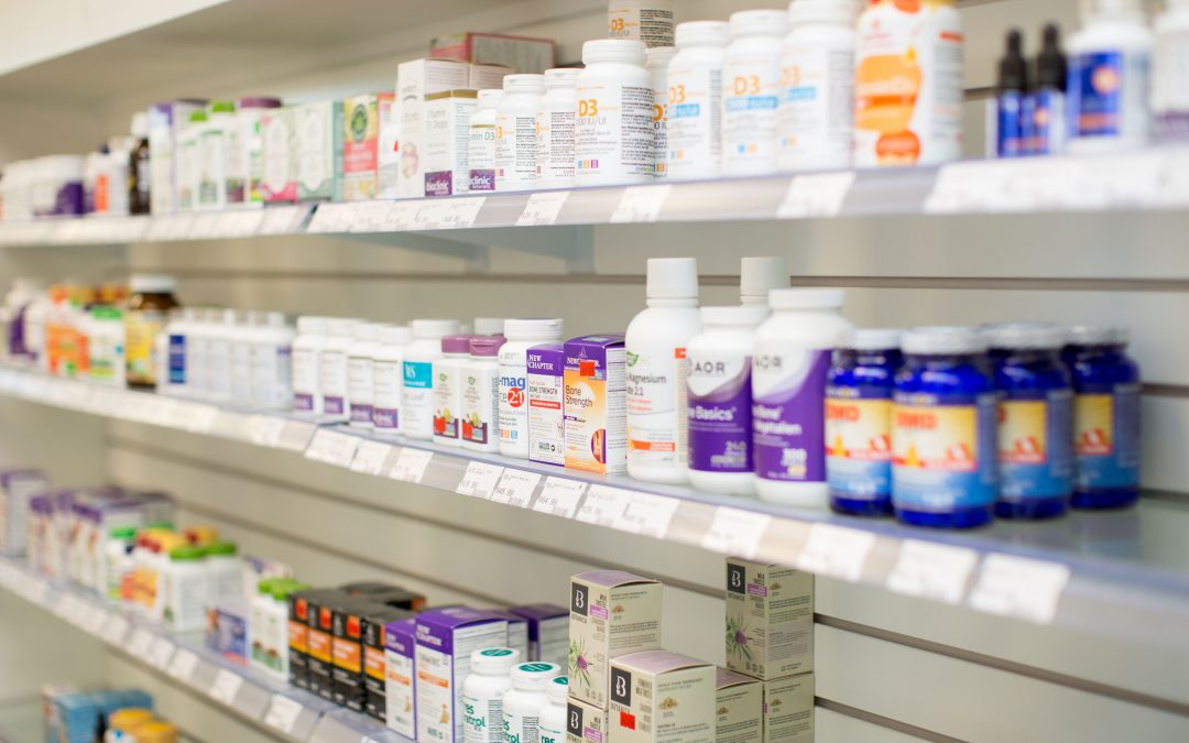 Shelves filled with various bottles and boxes of vitamins and supplements in a store.