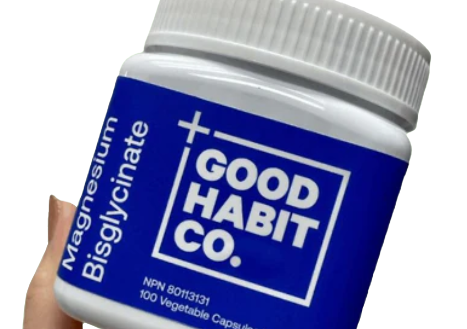 Hand holding a bottle of Good Habit Co. Magnesium Bisglycinate, with a blue label indicating 100 vegetable capsules.